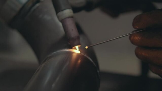 Professional Heavy Industry Welder working in industrial production factory. welding worker wearing helmet. Industrial Process, Heat Electrode Work. Metalwork Assembly, Construction