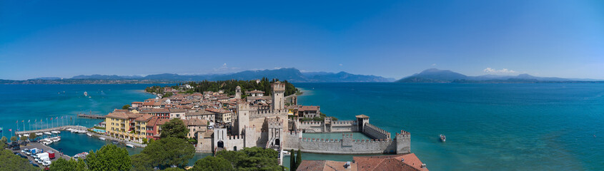 Fototapeta na wymiar Sirmione aerial panorama of Lake Garda, Italy. Aerial view of the historic castle on the water.