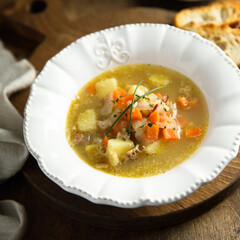 Homemade vegetable soup with smoked bacon
