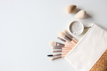 Naklejka premium Makeup accessories, brushes and sponges,pink pastel background,flat layot