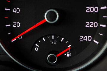 Close up of a fuel gauge showing a full fuel tank in a car, transportation with fossil fuel, efficiency of modern vehicles
