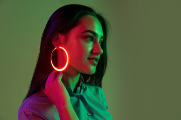 Young beautiful girl with fashion neon accessories, jewelry isolated over light background. Concept...