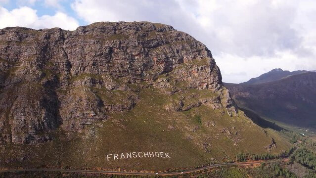 Aerial arc shows scenic route of Franschhoek mountain pass, South Africa