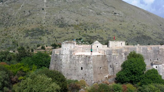 Aerial view of a person standing on top of Ali Pasha Castle in Porto Palermo bay, Albania.