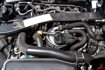 Fototapeta premium New fuel filter installed on a modern diesel car in the engine compartment.