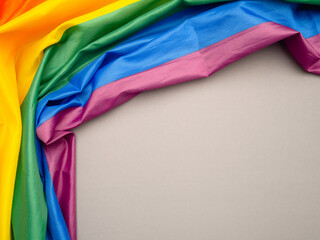 Top view of the rainbow flag or LGBT is on a gray background with copy space