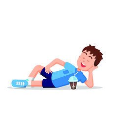 boy relaxing while lying on the floor and having a cold drink in front of him