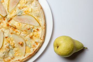 Tasty pizza with pear and cooking ingredients with kitchen toolson white background. With copy space for text. Flat lay. Banner 