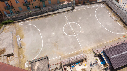 Aerial view of a soccer field and children's play area within a neighborhood of houses in the Francioso district of Potenza, Italy. - obrazy, fototapety, plakaty