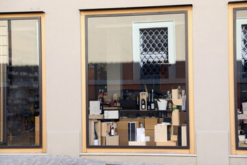 Bottles of different alcohol in wine shop, view through window