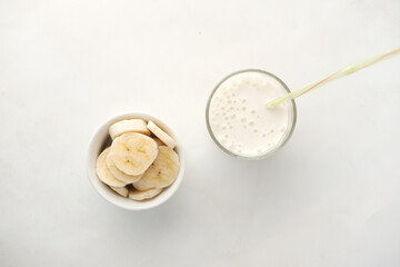  glass of milk and banana on table at morning 