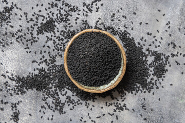 Indian spice Black cumin (nigella sativa or kalonji) seeds in bowl top view