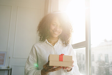 Excited african American young woman unpack gift box, overjoyed girl feel euphoric   