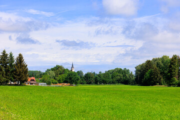 Rural area near Langehringen in Bavaria with green meadows ind blue sky