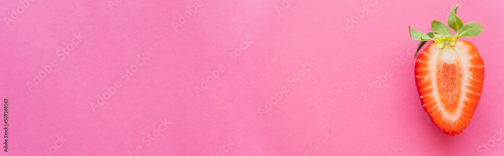 Canvas Prints Top view of natural cut strawberry on pink background, banner.