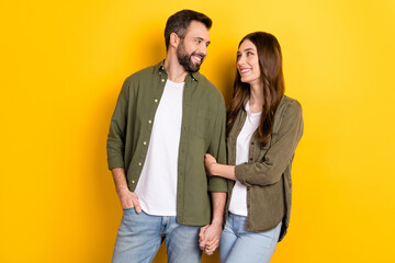 Portrait of attractive cheerful couple hugging spending free time harmony isolated over bright yellow color background