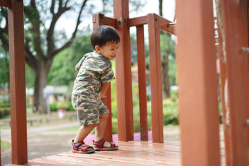 Asian boy playing and having fun at kid training playground