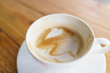 Cup of coffee with latte art pattern milk foam