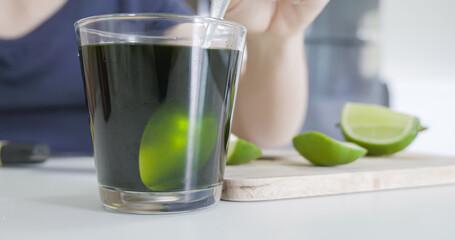 Mixing green tea with lime and honey.