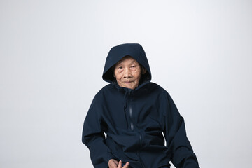 Senior Asian man wearing black anti static or wet weather hood jacket. A 95 years old guy with a...