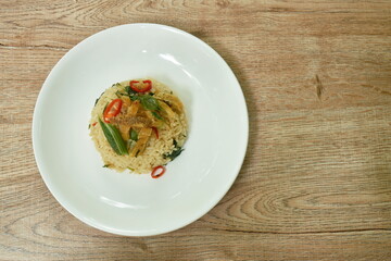 spicy fried rice with crispy gourami fish and egg on plate