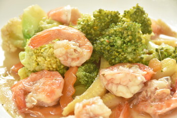 stir fried slice broccoli and carrot with shrimp on plate   