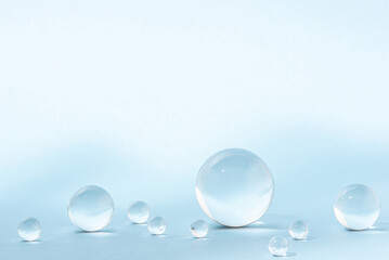 Fototapeta na wymiar Blue background with transparent glass balls.