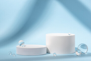 White podium with glass balls on a blue background.