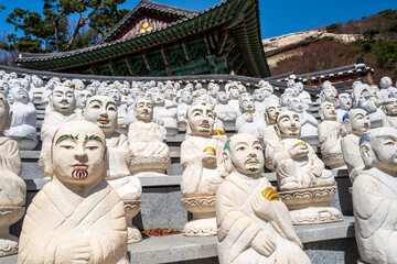 Some of the 500 Buddha’s Disciples statues by a temple hall in Bomunsa Temple on the island of Seongmodo, Ganghwa, Incheon, South Korea.