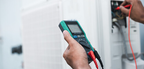 Air conditioner technicians use a multimeter to check electricity and Part of the preparation to install a new air conditioner.