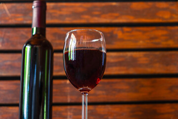 .Wine glass and wine bottle on the wooden table