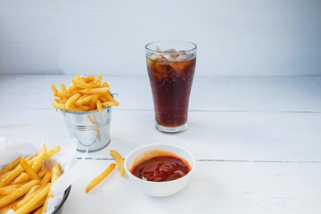 .Fried french fries and ketchup with soft drinks on the table