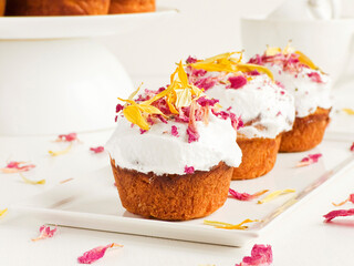 Cake with edible flowers and whipped cream. Shallow dof .