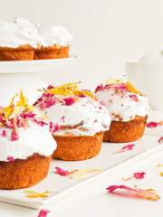 Cake with edible flowers and whipped cream. Shallow dof .