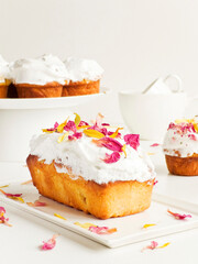 Cake with edible flowers and whipped cream. Shallow dof .