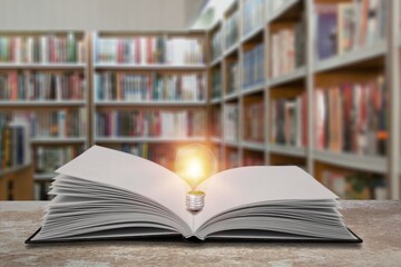 Light bulb on the open book, concept of innovation idea, knowledge. Self-learning and education.
