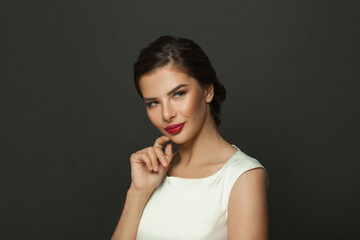 Perfect cheerful beautiful stylish brunette woman smiling on black background, fashion beauty portrait