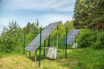 Large solar panel installed in a park area among the forest