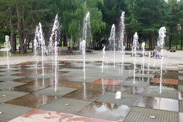 Dancing fountains in the city park in summer.