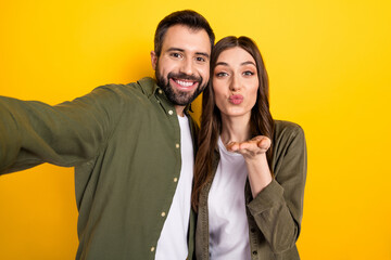 Photo of cute couple spend vacation together make video vlog take selfie isolated on yellow color background