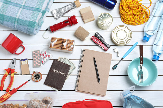 Disaster supply kit for earthquake on white wooden table, flat lay