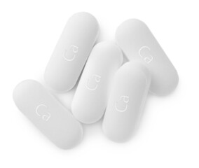 Pile of calcium supplement pills on white background, flat lay