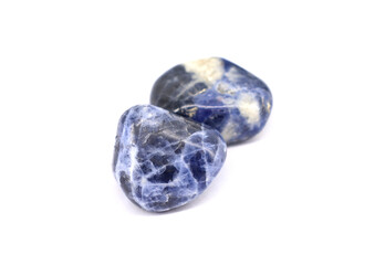 Sodalite, ornamental semi precious gemstone, on white background.