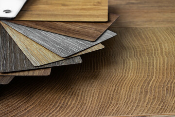 Sample of wood laminated chipboard for furniture design on wooden background with copy space. Color guide displaying a range of hues for use in interior design and decoration, for designers