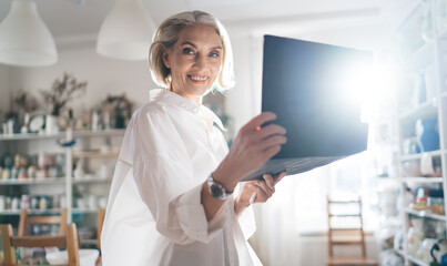Businesswoman with clipboard working at art studio