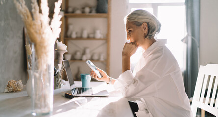 Female entrepreneur working at table at art studio