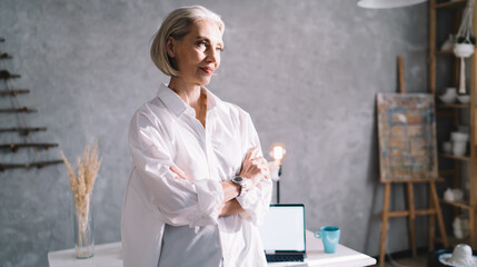 Businesswoman with crossed arms at home art studio