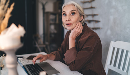 Female entrepreneur working at table at art studio