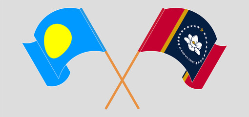 Crossed and waving flags of Palau and The State of Mississippi