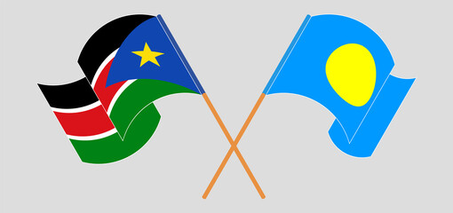 Crossed and waving flags of South Sudan and Palau